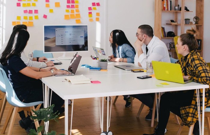 A team in an office discussing TEM during a meeting